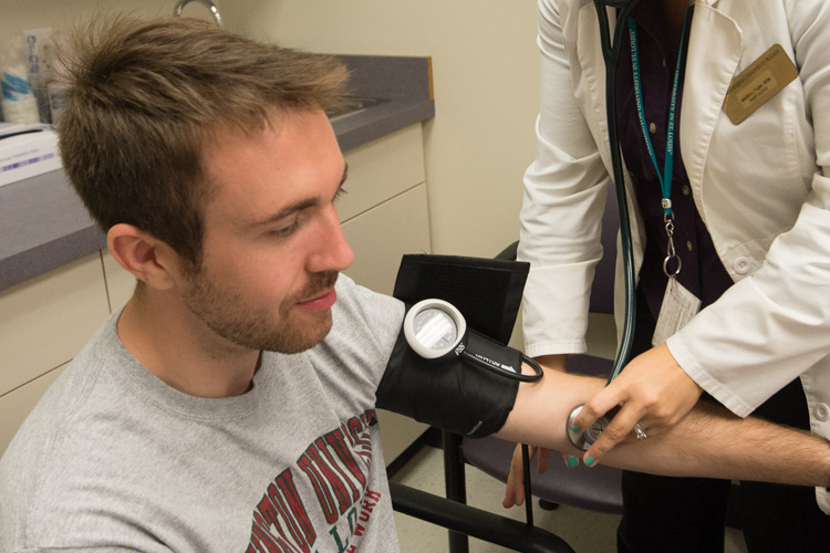 student receiving a blood pressure check